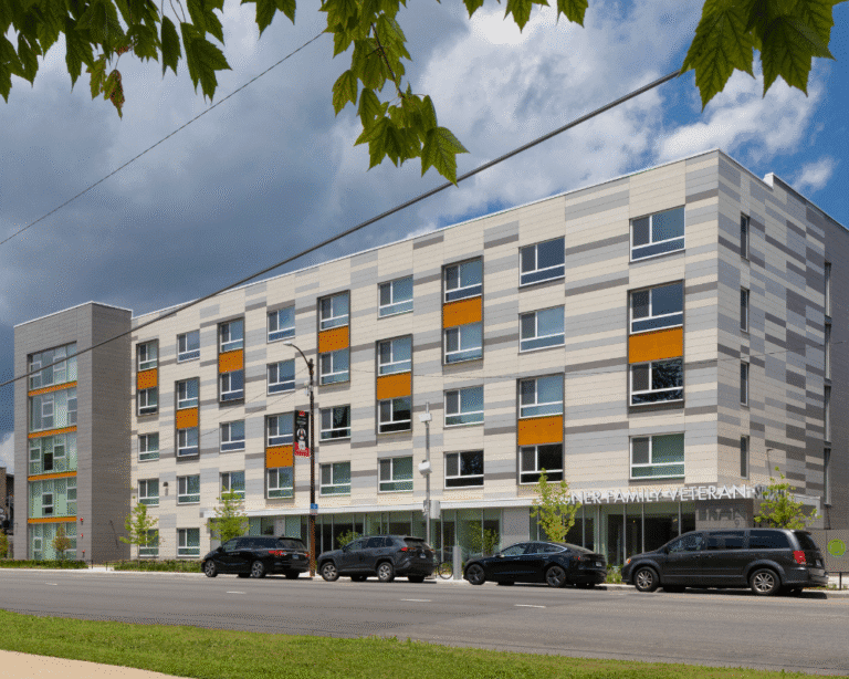 Contemporary building labeled 'Veteran' with cars parked in front