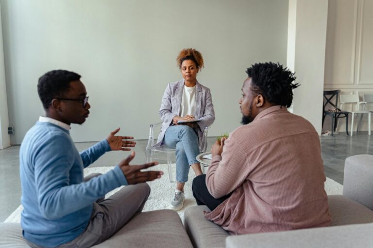 Facilitator mediating conversation between two men