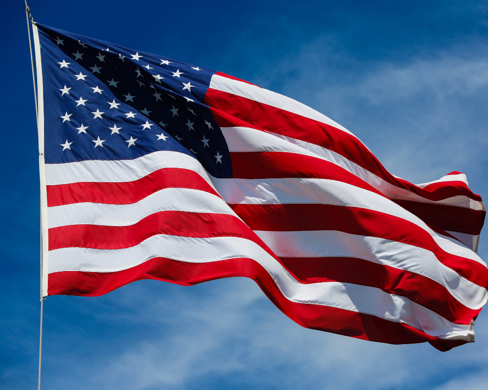 Close-up of the American flag waving in the sky