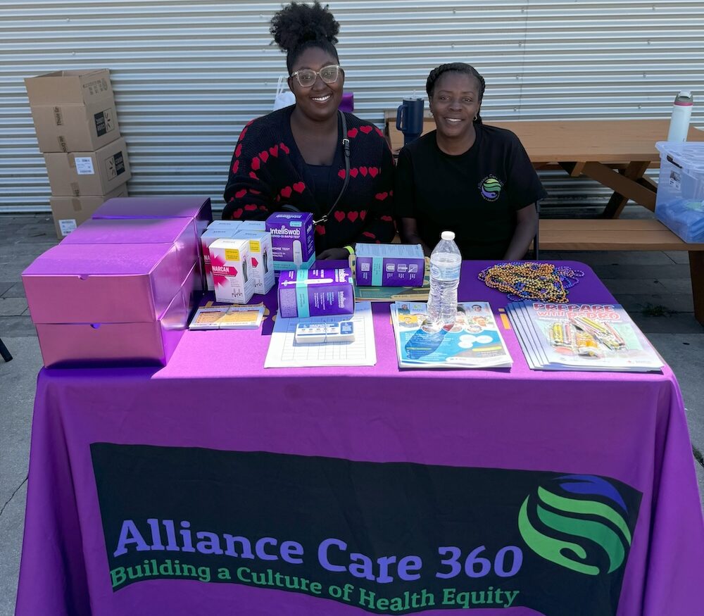 Alliance Care 360 staff tabling with healthcare resources.