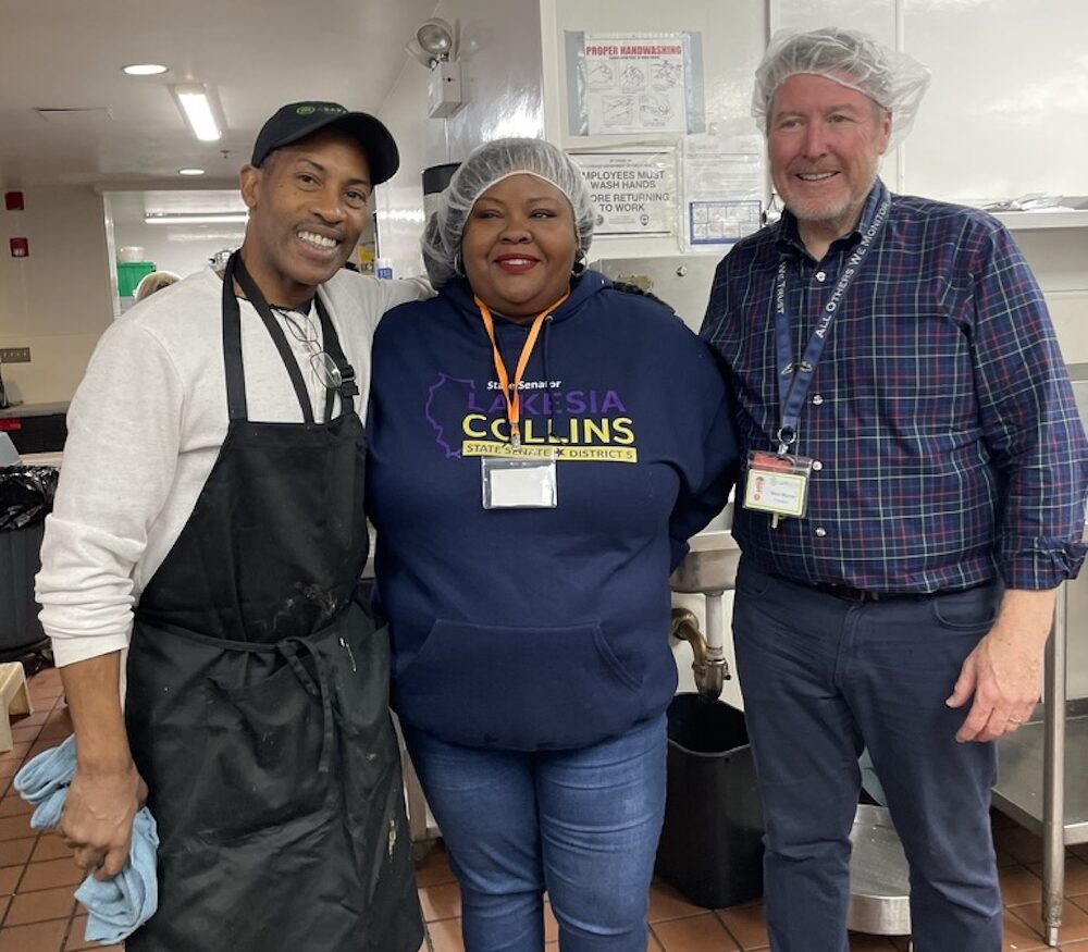 State Senator Collins poses with staff in the A Safe Haven Foundation kitchen.