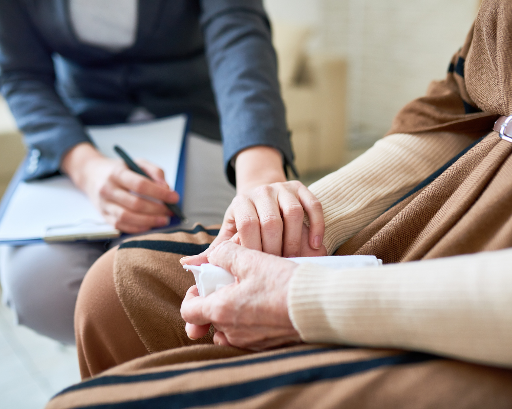 Close-up of a comforting hand on another person's hand