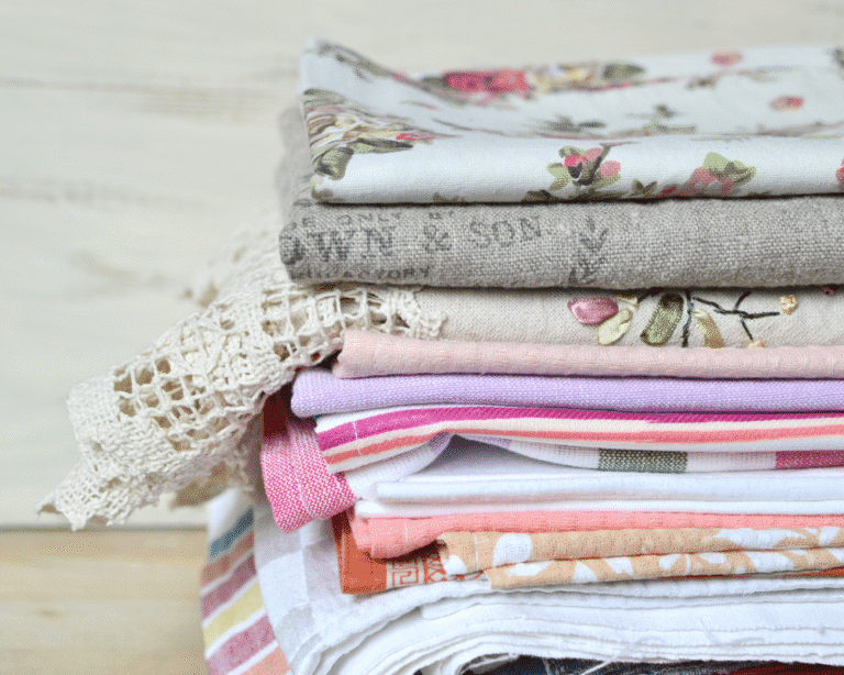 Stack of folded, colorful linens and towels