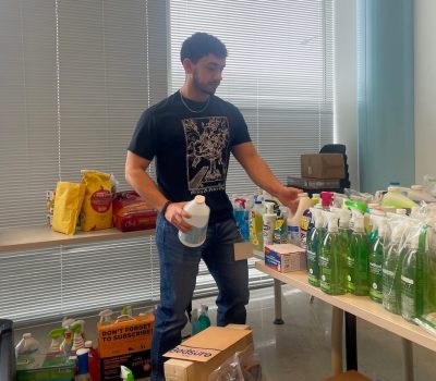 Volunteer organizing hygiene products and supplies indoors