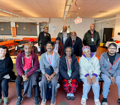 Group photo of program residents in a room with fall decorations